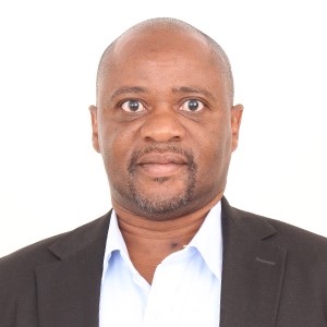 This is a professional portrait of a university lecturer and researcher specialising in Demography and Monitoring and Evaluation